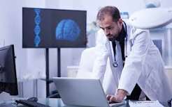 Physician reviewing a brain scan on a clinic monitor