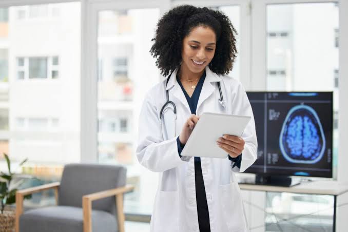 Clinician reviewing a brain scan on a tablet in the office