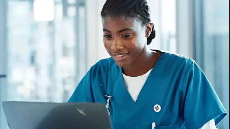 Nurse reviewing information on a laptop